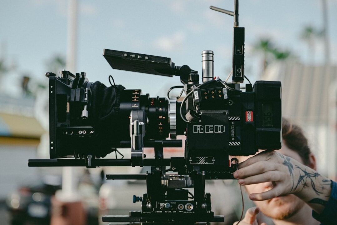 Camera operator holding a professional video camera on set